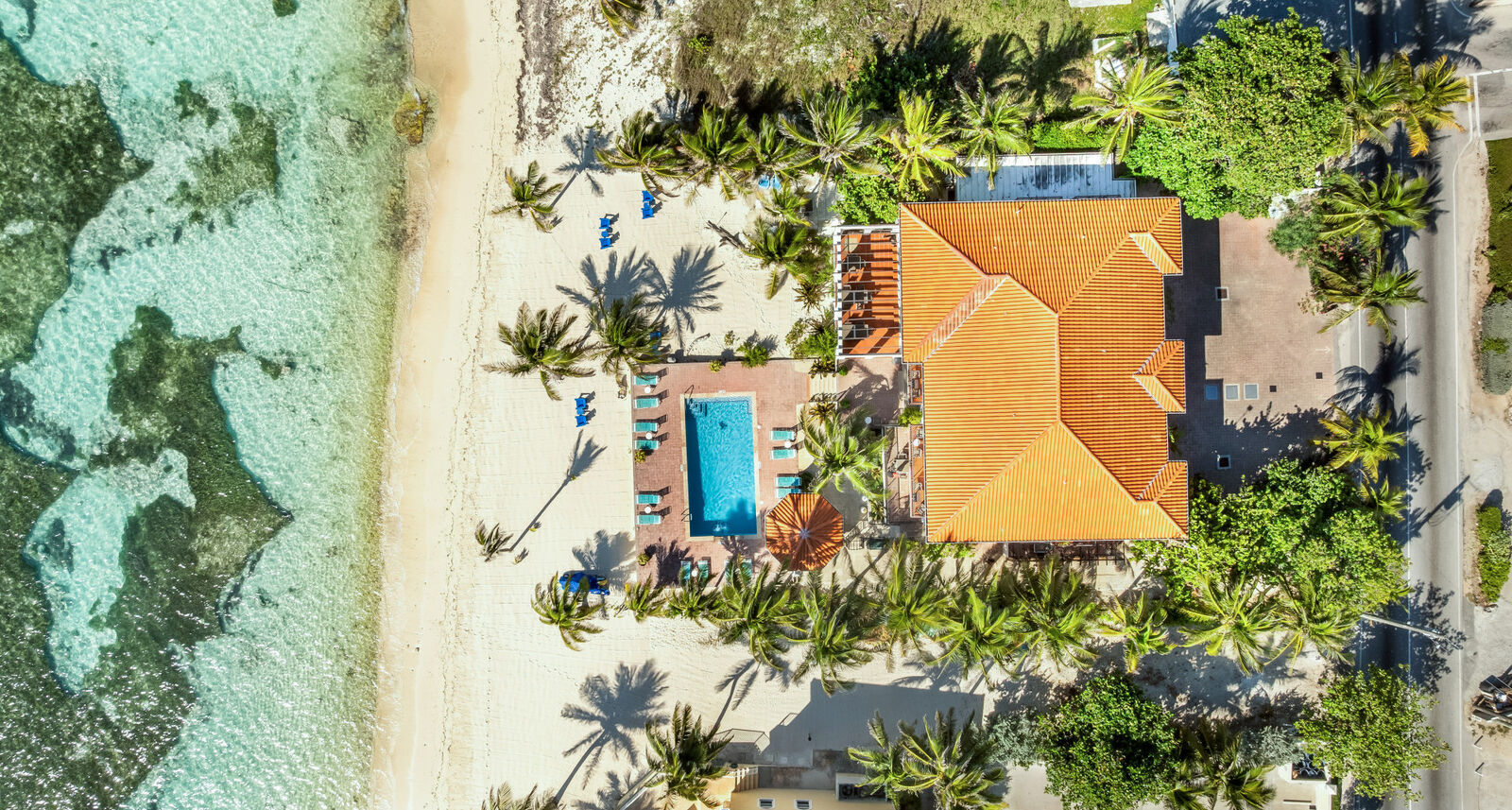 Aerial view of a beachfront home on the Cayman Islands coastline