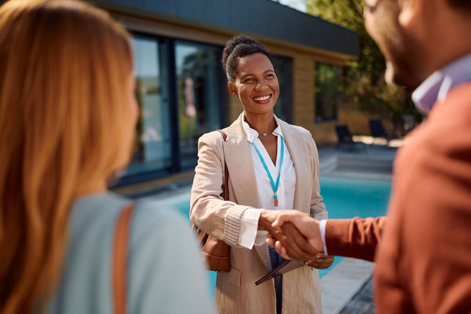 A CIREBA agent greeting clients beside a pool