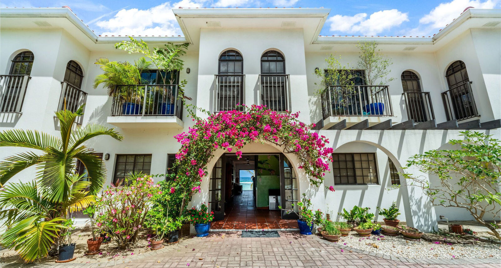 Arched villa entrance with bougainvillea in Grand Cayman